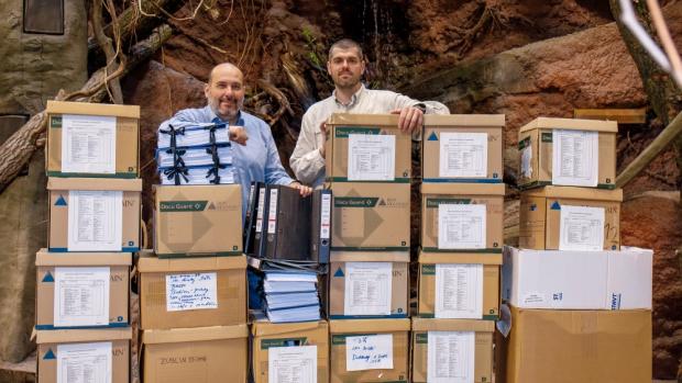 Miroslav Bobek, Prague Zoo’s director, and Lukáš Divoký, the head of the construction department, in front of the boxes with all the documentation necessary to get the occupancy permit. Prague Zoo photo archive 