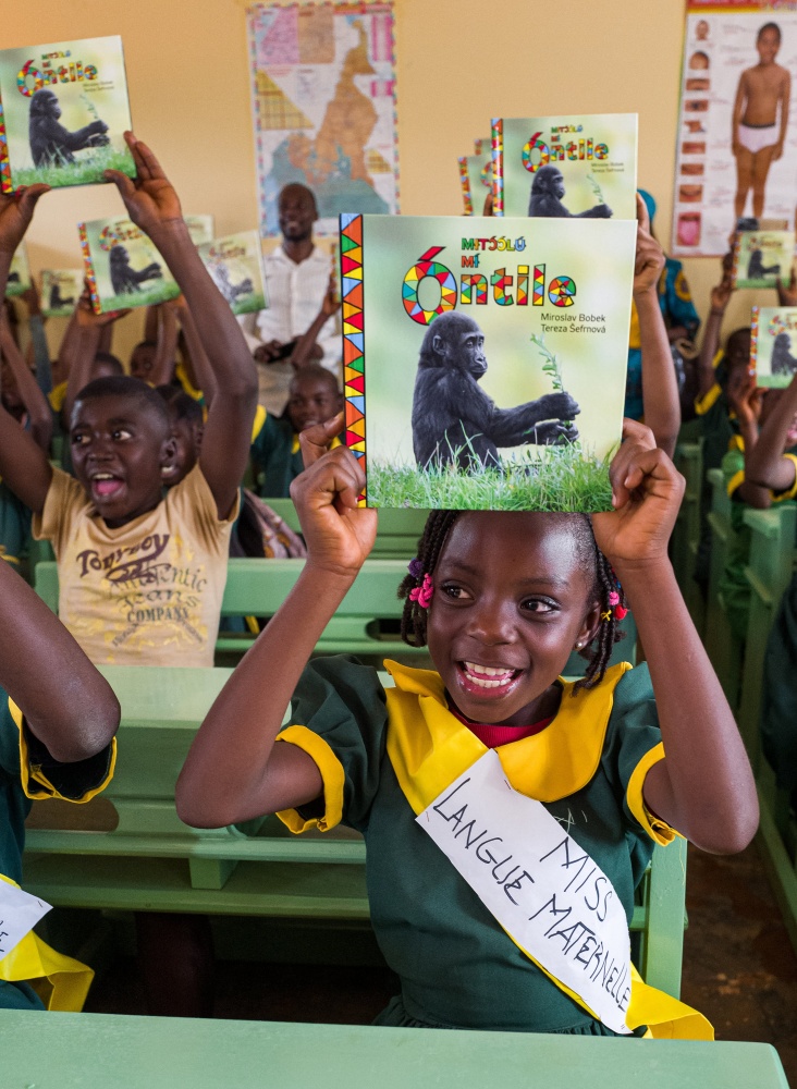 “Miss Mother Language” the eight-year-old Reine Azam Meloung, with a book of Gorilla Fairy Tales in the Bajwe’e dialect. Photo: Miroslav Bobek, Prague Zoo 